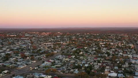 Sunrise hovering over Broken Hill city downtown streets and houses aerial 4k Stock Footage 168151853