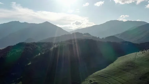 Sunrise illuminates forested mountain slopes and ridges Video stock 156884366