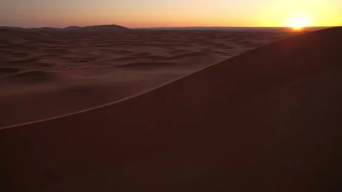 Sunrise illuminating the Erg Chebbi dune sea near Merzouga Morocco Stock Footage 338037974