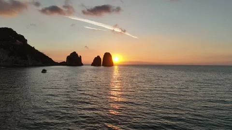 Sunrise on the island of Capri. the sun rises between the stacks. Faraglioni. Stock Footage 218477734