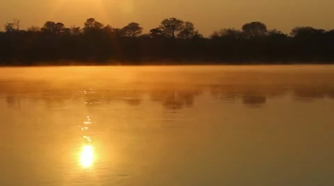 Sunrise at Kavango river whit mist on the water surface, Namibia. (B) Stock Footage 22308504