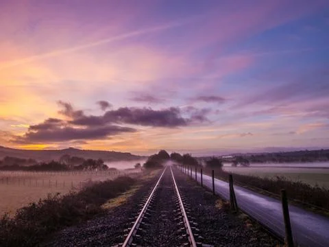 Sunrise light and perspective view on cycle path overlooking English countryside Stock Photos