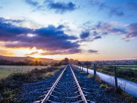 Sunrise light and perspective view on cycle path overlooking English countryside Stock Photos