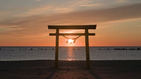 Sunrise light and Torii gate at the beach, Shizuoka, Japan Stock Footage 325833627