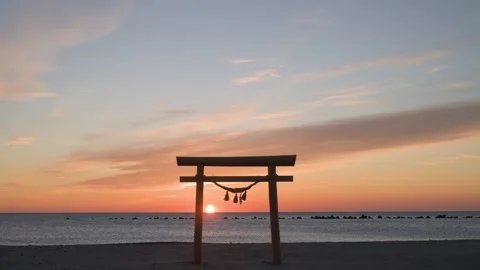 Sunrise light and Torii gate at the beach, Shizuoka, Japan 動画素材 325833649
