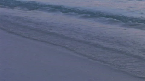 Sunrise light on calm ocean swapping against the beach  Video stock 480282
