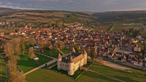 Sunrise light casting glow over Savigny-les-Beaune rooftops Stock Footage 306794107