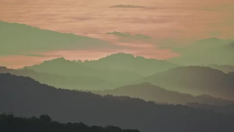 Sunrise Light Increasing Over Mountain Ridges and Foggy Valleys Time Lapse Video stock 282914379