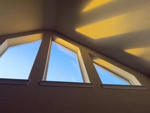Sunrise Light Shining Through Angled Windows Into Home Stock Photos