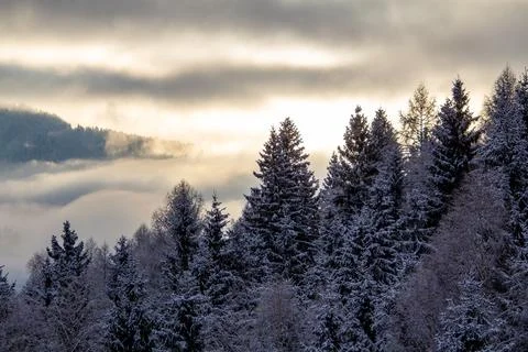 Sunrise makes a breakthrough in the mist between the mountains Stock Photos