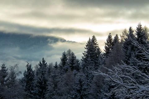 Sunrise makes a breakthrough in the mist between the mountains Stock Photos