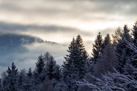 Sunrise makes a breakthrough in the mist between the mountains Stock Photos