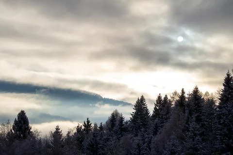 Sunrise makes a breakthrough in the mist between the mountains Stock Photos
