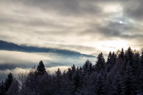 Sunrise makes a breakthrough in the mist between the mountains Stock Photos