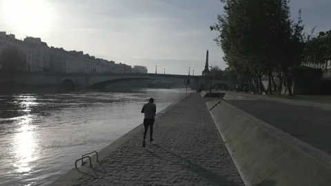 Sunrise man running tracking shot Paris Stock Footage 274797374