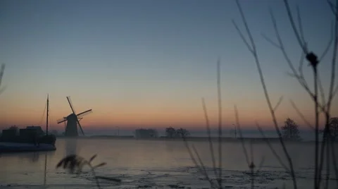 Sunrise with a mill and ship iced up river Stock Footage 40011908