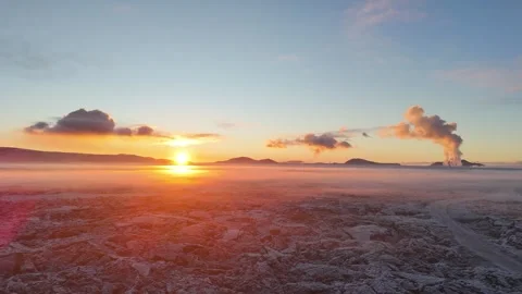 Sunrise Mist Drone Flight Over Frozen Lava Fields and Steaming Geothermal Peaks Stock Footage 322010937