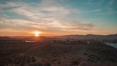 Sunrise from the mountains and clouds above the farm and a town Video stock 218362153