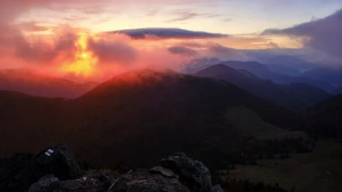 Sunrise in the mountains, clouds spill over the peaks of hills in the Carpathian Stock-Footage 254546399