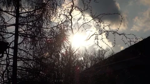 Sunrise with moving clouds over the roofs of the residential area Stock Footage 180138639