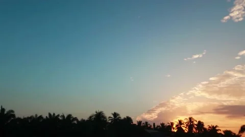 Sunrise n bright sun light ray or sunbeam flare on colorful blue sky Video stock 167411488