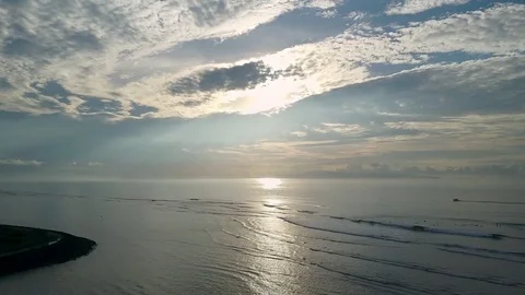 Sunrise in the ocean. The sun's rays slip through the clouds. Video stock 79355866
