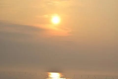 Sunrise in the ocean ,while seeing it from the beach,a very calm situation Stock Photos