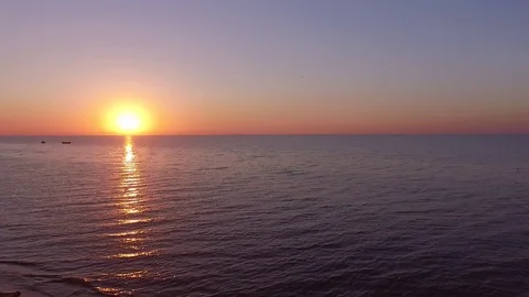 Sunrise or sunset, against the backdrop of the sea, the sea waves of fishing boa Stock Footage 129623981