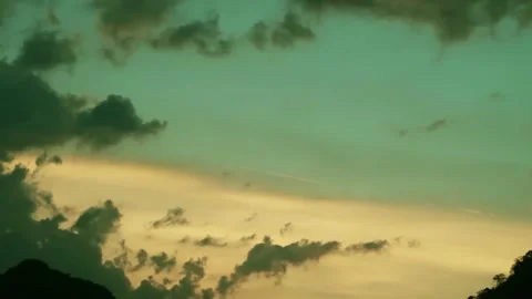 Sunrise or sunset with dark gray cloud on cyan blue n golden yellow sky Stock Footage 167690652