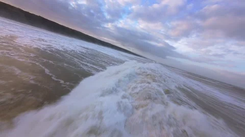 Sunrise or sunset light glows over stormy sea waves Video stock 344675253