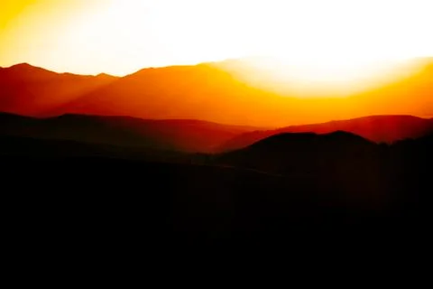 Sunrise or Sunset on Mountain Range Stock Photos