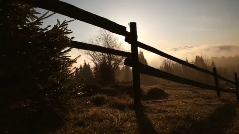 Sunrise or sunset in the mountains. Forest and wood fence in the mountains 스톡 동영상 76395207