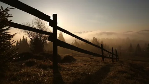 Sunrise or sunset in the mountains. Forest and wood fence in the Carpathian Stock Footage 77006821
