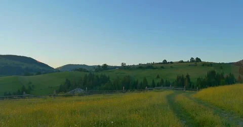 Sunrise or sunset in the mountains. Forest and wood fence in the mountains Stock Footage 77263193