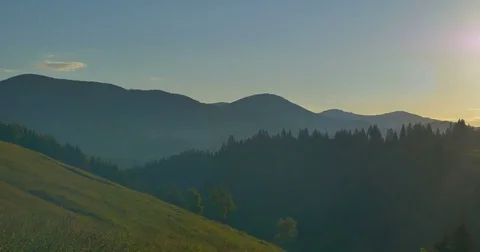 Sunrise or sunset in the mountains. Forest in the mountains. Panorama Beautiful Video stock 77263849