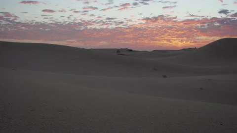 Sunrise or sunset over sand dunes in a desert Stock Footage 134356147