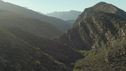 Sunrise or Sunset  Rays of Light Streak the Desert Valley Aerial Fly Through Stock Footage 119357139
