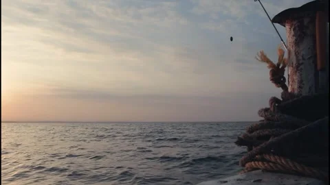 Sunrise or sunset view from a boat with mooring rope and fishing line Stock Footage 320090971