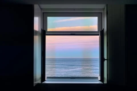 Sunrise over Atlantic Ocean through the open window Stock Photos