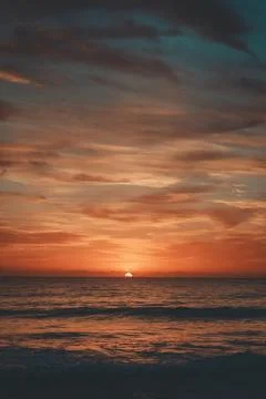 A sunrise over a beach. Stock Photos