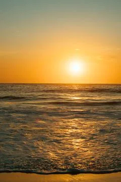 A sunrise over a beach. Stock Photos