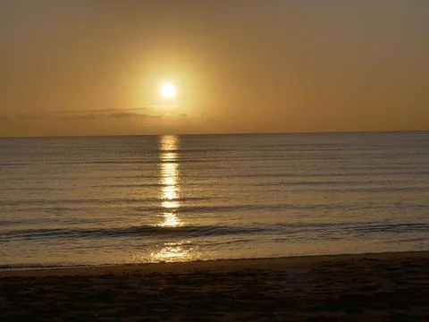 Sunrise over beach Stock Photos