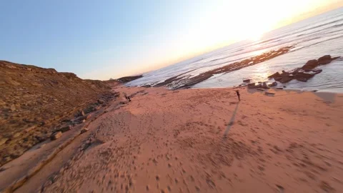 Sunrise over beach with waves breaking gently Stock Footage 344558443