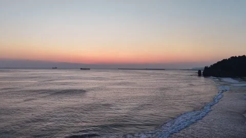 Sunrise over a Calm Beach and East Sea Coast in South Korea Stock Footage 344778155