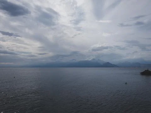 Sunrise over calm ocean with dramatic clouds 스톡 사진