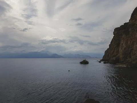 Sunrise over calm ocean with dramatic clouds 스톡 사진