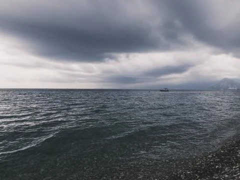 Sunrise over calm ocean with dramatic clouds Stock Photos
