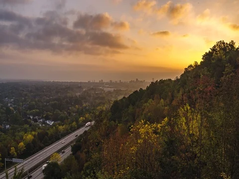 Sunrise over city and Highway Stock Footage