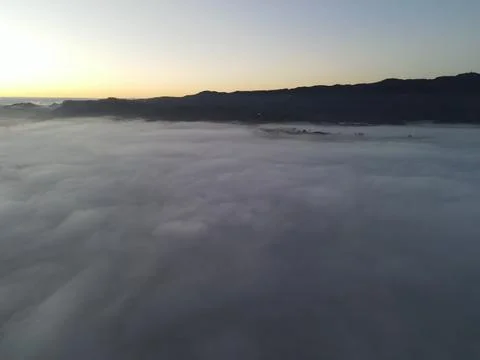 Sunrise over the clouds Stock Photos