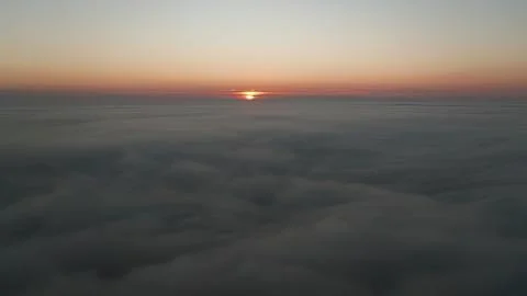Sunrise over clouds seen from above during morning flight Stock Photos